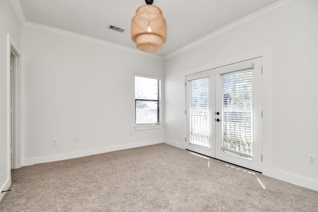 carpeted spare room with ornamental molding and french doors