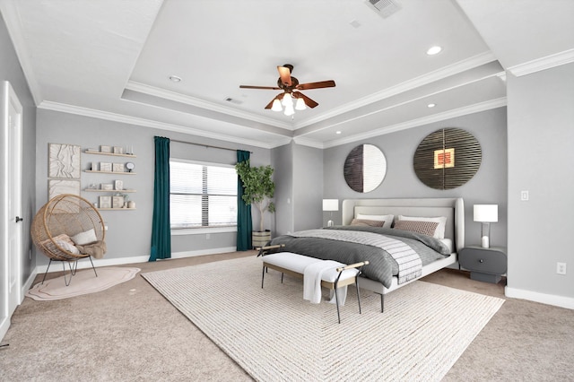 bedroom featuring carpet flooring, ceiling fan, crown molding, and a tray ceiling