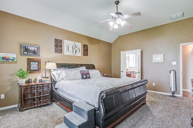 carpeted bedroom featuring ensuite bath, ceiling fan, and lofted ceiling