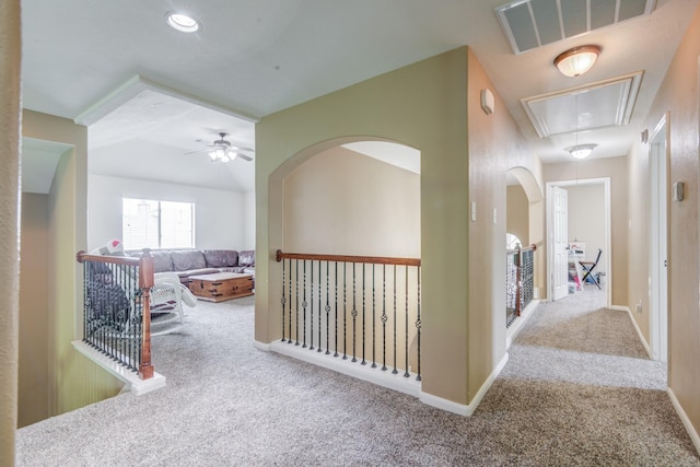 hallway featuring light colored carpet