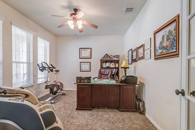 carpeted office with ceiling fan