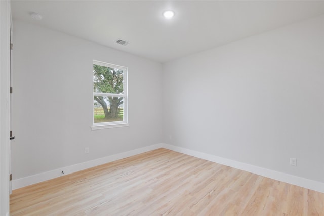 empty room with light hardwood / wood-style flooring