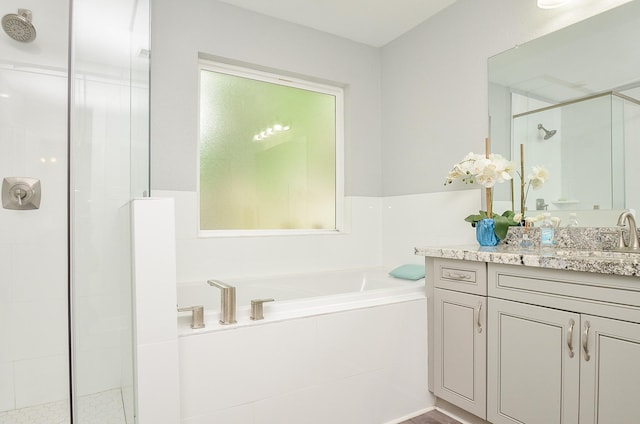 bathroom featuring plus walk in shower and vanity