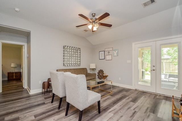 living area featuring hardwood / wood-style flooring, ceiling fan, lofted ceiling, and french doors