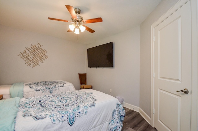 bedroom featuring ceiling fan and dark wood-type flooring