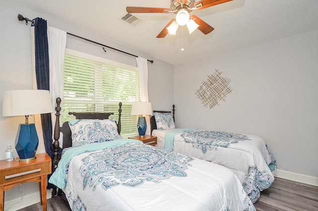 bedroom featuring dark hardwood / wood-style floors and ceiling fan