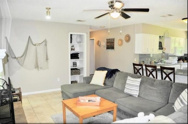 living room with ceiling fan and light tile patterned floors