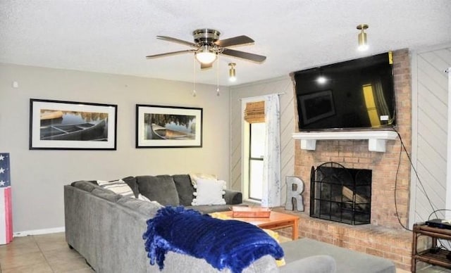 tiled living room with a fireplace, a textured ceiling, and ceiling fan