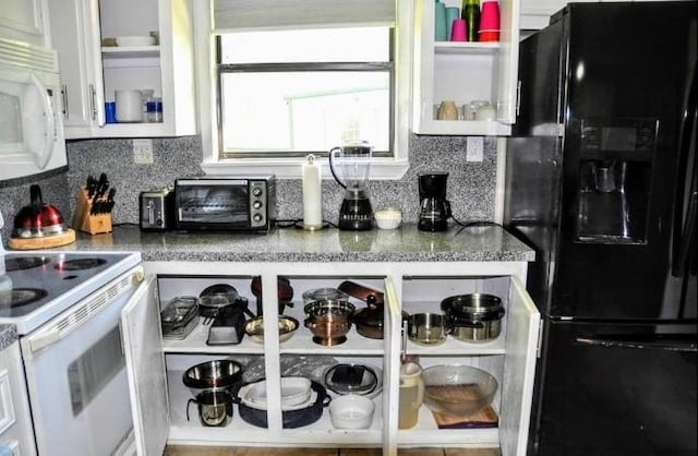 kitchen with white cabinets, white appliances, and tasteful backsplash