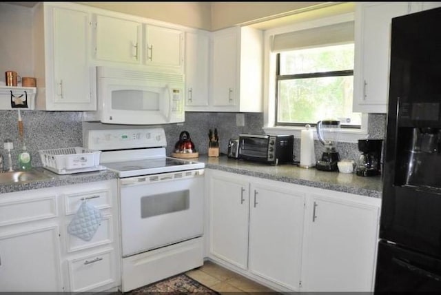 kitchen featuring tasteful backsplash, white cabinets, light tile patterned flooring, and white appliances