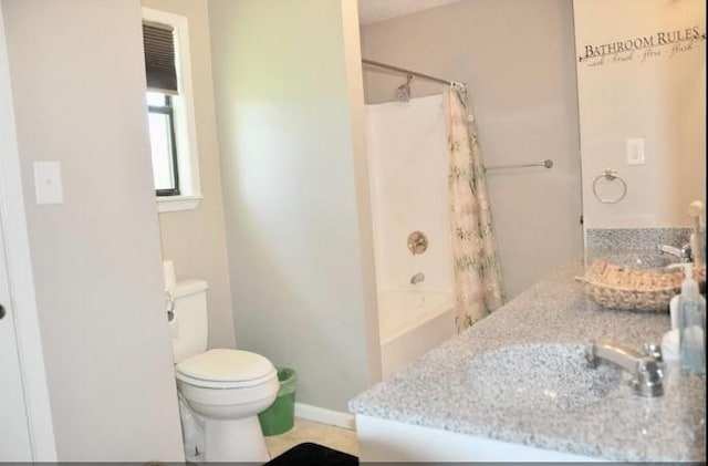 full bathroom with shower / bath combination with curtain, vanity, and toilet