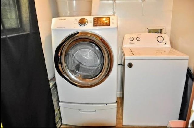 clothes washing area featuring washer and clothes dryer