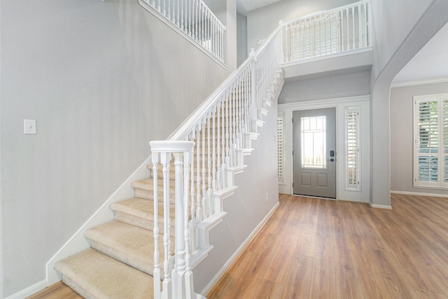 foyer with ornamental molding and hardwood / wood-style flooring