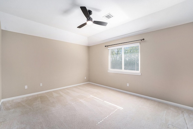 carpeted spare room featuring ceiling fan and lofted ceiling