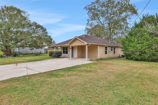 single story home featuring cooling unit, a front yard, and a carport