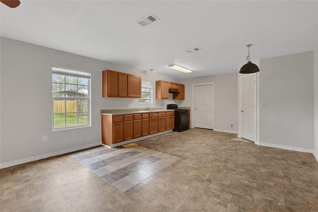 kitchen with black range with electric stovetop and hanging light fixtures