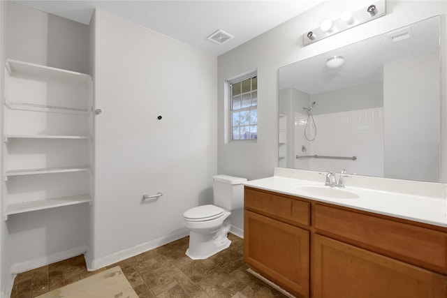 bathroom featuring vanity, toilet, and walk in shower