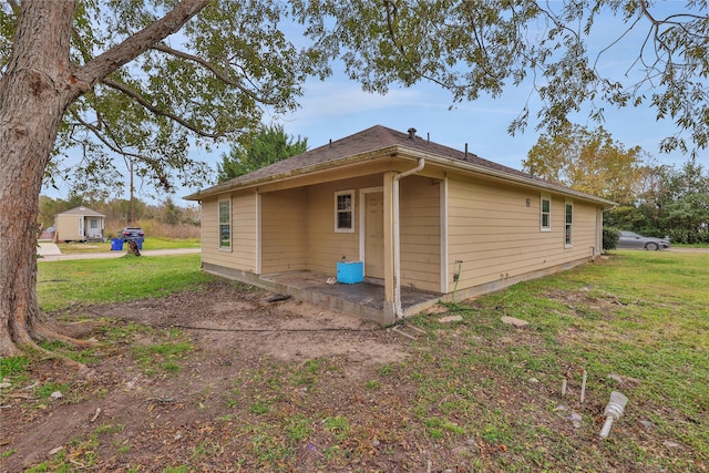 view of side of property with a yard