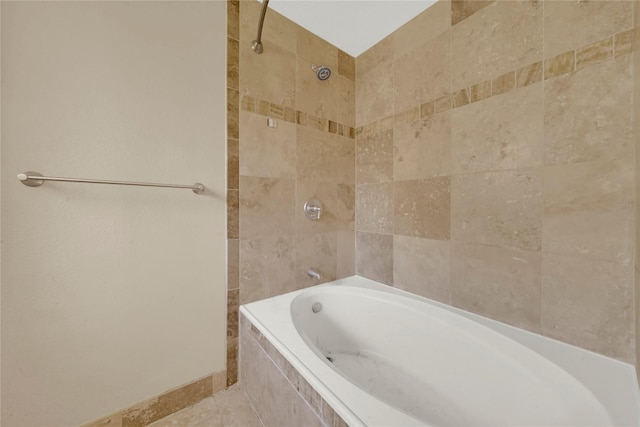 bathroom with tiled shower / bath combo and tile patterned floors