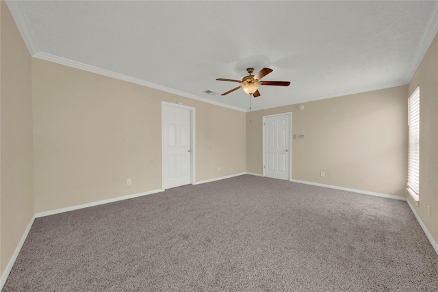 carpeted spare room with ceiling fan and ornamental molding