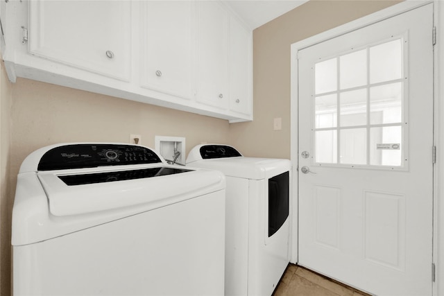 laundry area featuring cabinets, independent washer and dryer, and light tile patterned flooring