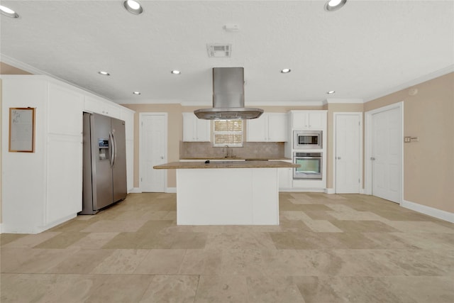 kitchen with island exhaust hood, appliances with stainless steel finishes, backsplash, white cabinets, and a center island