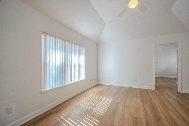 empty room featuring light hardwood / wood-style floors, ceiling fan, and lofted ceiling