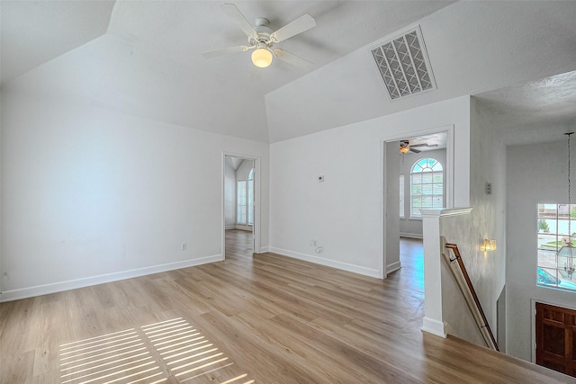 unfurnished living room featuring a textured ceiling, light hardwood / wood-style flooring, and plenty of natural light