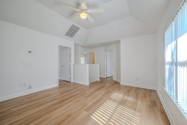 unfurnished living room featuring ceiling fan, light wood-type flooring, and vaulted ceiling