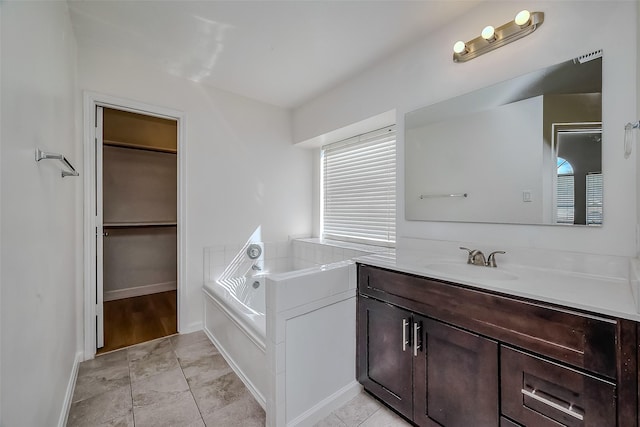 bathroom with vanity, tile patterned floors, and a bathing tub