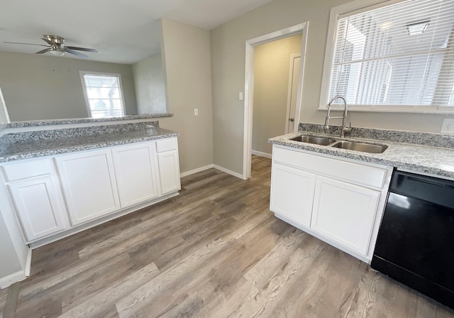 kitchen with dishwasher, white cabinets, and sink