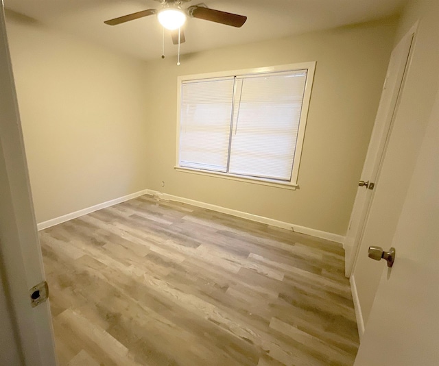 empty room featuring light wood-type flooring and ceiling fan