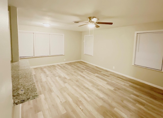 spare room with ceiling fan and light hardwood / wood-style flooring