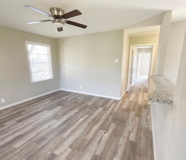 spare room featuring ceiling fan and light hardwood / wood-style floors