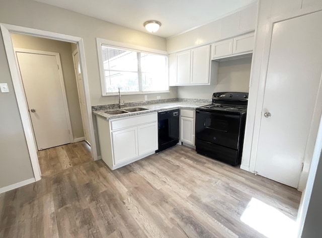 kitchen featuring sink, white cabinets, black appliances, and light hardwood / wood-style flooring