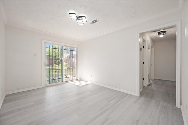 spare room with light hardwood / wood-style floors, a textured ceiling, and ornamental molding