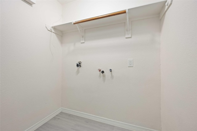 clothes washing area with gas dryer hookup, hookup for a washing machine, and hardwood / wood-style flooring