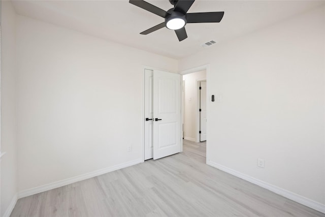 spare room featuring light hardwood / wood-style floors and ceiling fan