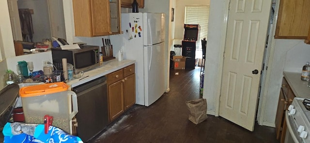 kitchen featuring dark hardwood / wood-style flooring and white appliances