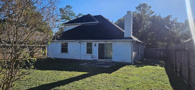 rear view of property with a patio area and a lawn