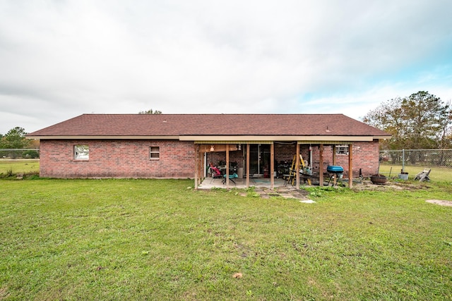 rear view of property with a yard and a patio