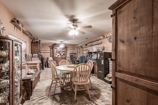 dining room with a textured ceiling and ceiling fan