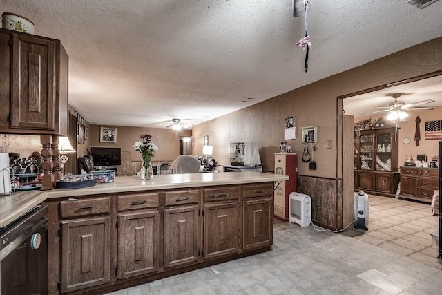 kitchen with dishwasher, ceiling fan, dark brown cabinetry, and a textured ceiling