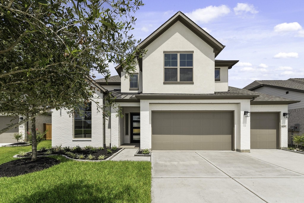 view of front of home featuring a garage and a front lawn