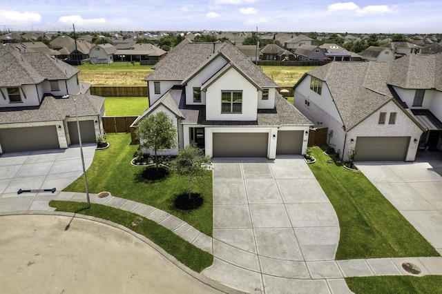 view of front of home featuring a front lawn and a garage