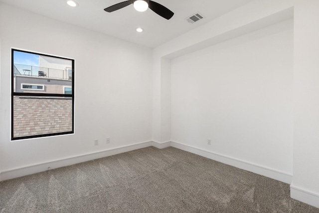 carpeted spare room with ceiling fan