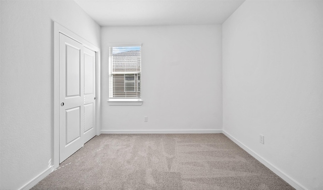 empty room with light colored carpet