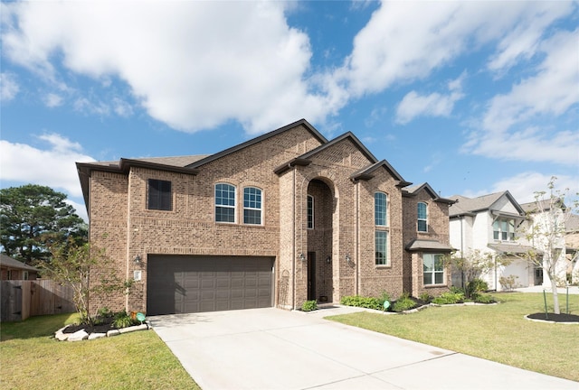 view of front of property featuring a front lawn and a garage