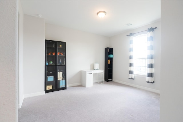 miscellaneous room with light colored carpet