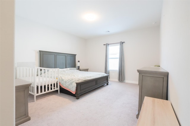 bedroom with light colored carpet